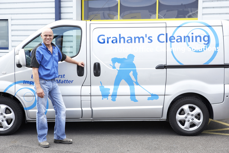 Fleet vehicle with a man standing next to it