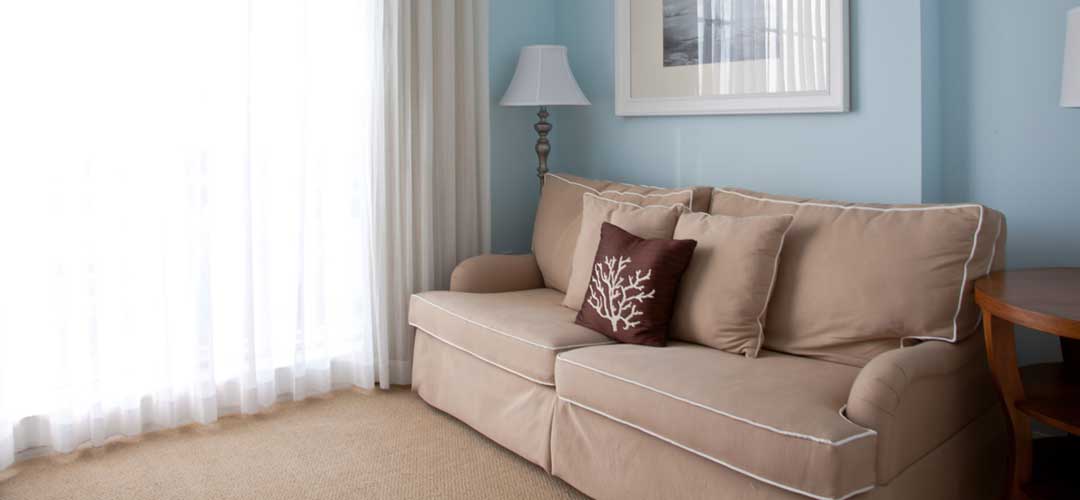 Beautiful tan sofa with pillows 