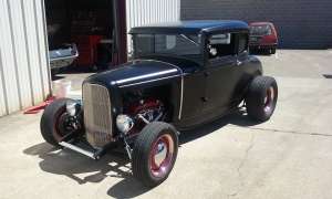 Black hot rod leaving the shop with a new custom interior