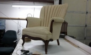 restored antique chair in soft cream fabric with wooden accents